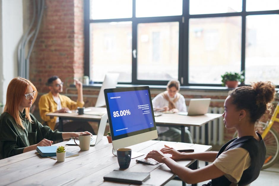 Coworking space with diverse team collaborating on technology projects, creating a dynamic work environment.