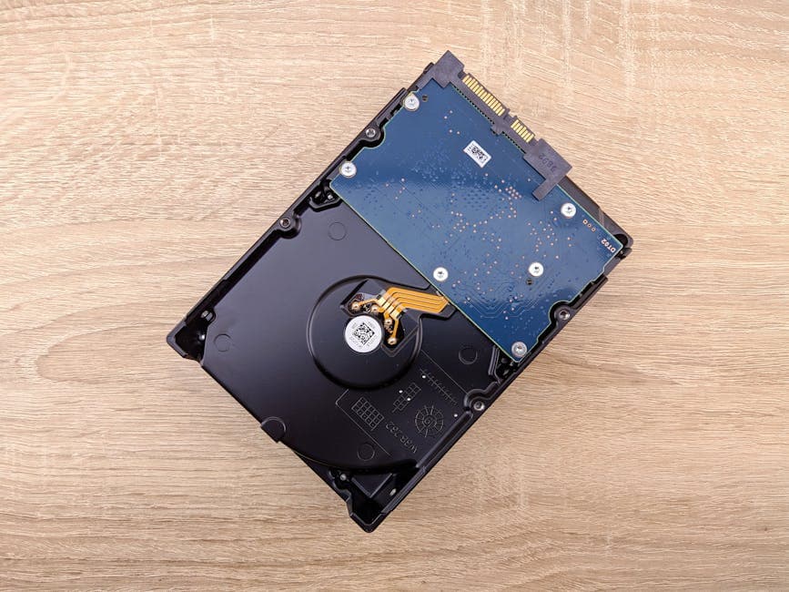 From above layout composition of modern internal hard drive placed on wooden surface
