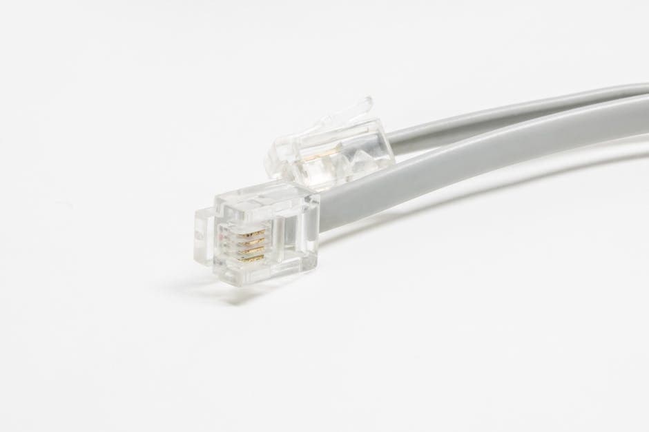 Detailed shot of an Ethernet cable connector on a white background.