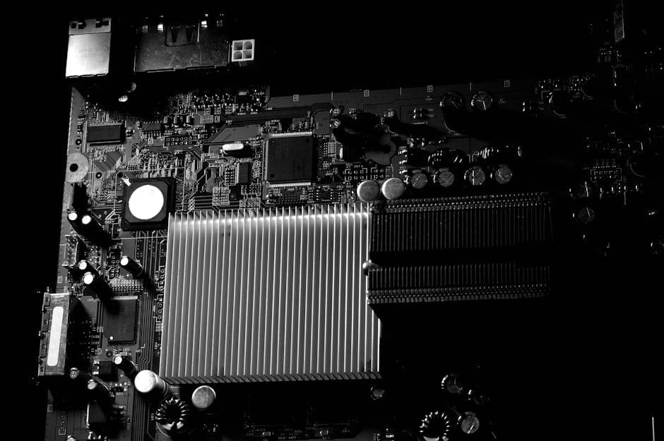 Detailed black and white photo of a computer motherboard highlighting the heatsink.
